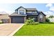 Charming two-story home with a well-manicured lawn and beautiful landscaping at 4889 Oakleigh Pkwy, Greenwood, IN 46143