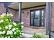 Inviting front porch featuring a decorative brick wall and blooming bushes at 4889 Oakleigh Pkwy, Greenwood, IN 46143