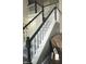 Carpeted staircase with black and white railings next to a brown couch at 4889 Oakleigh Pkwy, Greenwood, IN 46143