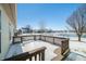 An open backyard features a spacious deck, offering a serene view of the nearby pond and community at 5316 Twin Bridge Blvd, Indianapolis, IN 46239