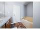 Bathroom featuring a double vanity and tiled soaking tub at 5316 Twin Bridge Blvd, Indianapolis, IN 46239