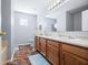Spacious bathroom with dual sinks, tiled floors, and white counters at 5316 Twin Bridge Blvd, Indianapolis, IN 46239