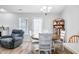 Open dining area featuring a round wood table and a comfortable gray recliner at 5316 Twin Bridge Blvd, Indianapolis, IN 46239
