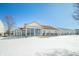 Rear exterior of house with sunroom addition and snowy yard at 5316 Twin Bridge Blvd, Indianapolis, IN 46239