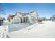 Rear exterior of house with sunroom addition, shed and snowy yard at 5316 Twin Bridge Blvd, Indianapolis, IN 46239