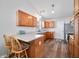 Kitchen with wood cabinets, breakfast bar, and sleek countertops at 5316 Twin Bridge Blvd, Indianapolis, IN 46239