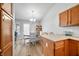 Open view of kitchen and dining area with wood cabinetry and flooring at 5316 Twin Bridge Blvd, Indianapolis, IN 46239
