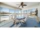 Enclosed sunroom with four chairs, glass table, and fan at 5316 Twin Bridge Blvd, Indianapolis, IN 46239