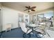 Enclosed sunroom with four chairs, glass table, and fan at 5316 Twin Bridge Blvd, Indianapolis, IN 46239