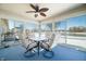 Enclosed sunroom with four chairs, glass table, and fan at 5316 Twin Bridge Blvd, Indianapolis, IN 46239