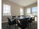 Bright conference room with large windows, neutral tones, and seating for eight around the table at 5558 Tart Blvd, Indianapolis, IN 46239