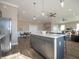 Spacious kitchen boasts a large island with seating, modern lighting, and an open layout at 5558 Tart Blvd, Indianapolis, IN 46239