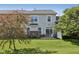 Private backyard featuring a well-maintained lawn, patio area, mature trees, and partial privacy fence at 5682 Castor Way, Noblesville, IN 46062