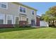 A charming backyard with a sliding glass door, small patio, brick accents, and lush green grass at 5682 Castor Way, Noblesville, IN 46062