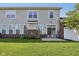 The backyard features sliding doors, a patio, a well-maintained lawn, and brick accents at 5682 Castor Way, Noblesville, IN 46062
