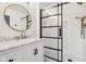 Contemporary bathroom with glass-enclosed shower, marble vanity, and round mirrors at 5682 Castor Way, Noblesville, IN 46062