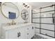 Bright bathroom featuring double vanity, marble countertop, and a modern black-framed glass shower at 5682 Castor Way, Noblesville, IN 46062