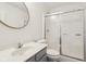 Bright bathroom featuring a modern vanity, a gold-rimmed round mirror, and a glass-enclosed shower at 5682 Castor Way, Noblesville, IN 46062