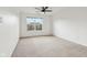 Bright, spacious bedroom with a ceiling fan and a large window overlooking a serene neighborhood at 5682 Castor Way, Noblesville, IN 46062