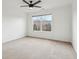 A spacious bedroom featuring neutral carpeting, a ceiling fan and a large window at 5682 Castor Way, Noblesville, IN 46062
