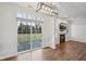 Dining area with sliding glass doors, hardwood flooring, and decorative light fixture at 5682 Castor Way, Noblesville, IN 46062