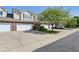 View of the townhouse and driveway in a community with beautiful lawns and landscaping at 5682 Castor Way, Noblesville, IN 46062