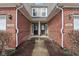 Close-up view of the entrance of two townhomes, showcasing brickwork and well-maintained front doors at 5682 Castor Way, Noblesville, IN 46062