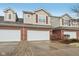 Attractive townhome featuring a brick facade, attached two-car garage, and well-maintained landscaping at 5682 Castor Way, Noblesville, IN 46062