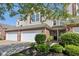 Charming two-story townhouse with a brick facade, well-kept lawn, and an attached one-car garage at 5682 Castor Way, Noblesville, IN 46062