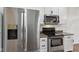 Stainless steel appliances and white cabinetry offer modern style in this well-lit kitchen at 5682 Castor Way, Noblesville, IN 46062