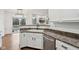 Kitchen boasts a stainless steel dishwasher and a neutral countertop with white cabinets at 5682 Castor Way, Noblesville, IN 46062