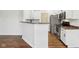 Kitchen view features stainless steel appliances, white cabinets, and breakfast bar area at 5682 Castor Way, Noblesville, IN 46062