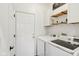Well-organized laundry room with modern washer and dryer, ample shelving, and efficient layout at 5682 Castor Way, Noblesville, IN 46062