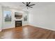 Living room showcases a cozy fireplace, TV, hardwood floors, and natural lighting at 5682 Castor Way, Noblesville, IN 46062