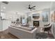 Inviting living room with fireplace, dining area, and sliding glass door, offering a seamless indoor-outdoor living experience at 5682 Castor Way, Noblesville, IN 46062
