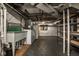 Unfinished basement area with exposed pipes, utility sink, and shelving, offering practical storage space at 5736 Central Ave, Indianapolis, IN 46220