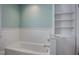 Bathroom featuring a bathtub with built-in shelving and white subway tile at 5736 Central Ave, Indianapolis, IN 46220