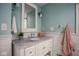 Bathroom featuring a white vanity with marble countertop, framed mirror, and modern fixtures at 5736 Central Ave, Indianapolis, IN 46220