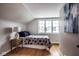 Attic bedroom featuring a bed, a nightstand with a lamp and a large window at 5736 Central Ave, Indianapolis, IN 46220