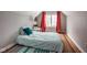 Cozy attic bedroom featuring a bed with colorful accents and a bright window view at 5736 Central Ave, Indianapolis, IN 46220