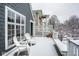 Snowy deck area featuring outdoor chairs, white lattice, and a view of neighboring homes in a winter landscape at 5736 Central Ave, Indianapolis, IN 46220