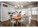 Charming dining room with a wooden table, white chairs, and modern chandelier at 5736 Central Ave, Indianapolis, IN 46220