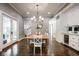 Bright dining room with a wooden table, white chairs, and modern chandelier at 5736 Central Ave, Indianapolis, IN 46220