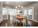 Charming dining room with a wooden table, white chairs, and modern chandelier at 5736 Central Ave, Indianapolis, IN 46220