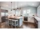 Bright kitchen with stainless steel appliances, a large island, and hardwood floors at 5736 Central Ave, Indianapolis, IN 46220