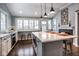 Open kitchen featuring an island with seating, a fireplace and stainless appliances at 5736 Central Ave, Indianapolis, IN 46220