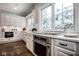 A close-up shot of the white kitchen with stainless steel appliances and dark wood floors at 5736 Central Ave, Indianapolis, IN 46220