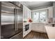 Modern kitchen with stainless steel appliances, white cabinetry, and ample counter space at 5736 Central Ave, Indianapolis, IN 46220