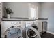This laundry room features side by side washer and dryer, a utility sink and lots of counter space at 5736 Central Ave, Indianapolis, IN 46220