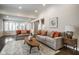 Bright and airy living room with hardwood floors, neutral-colored walls, and comfortable furnishings at 5736 Central Ave, Indianapolis, IN 46220